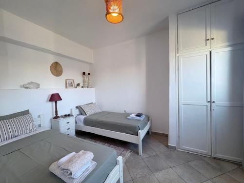 a bedroom with a bed and a dresser at Armeos Blue in Myrties