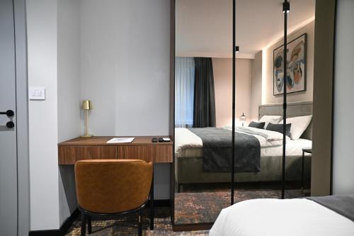 a bedroom with a mirror and a desk and a bed at Black Gallo Residences in Belgrade