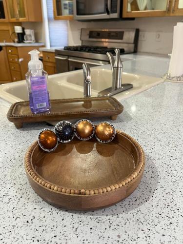 a kitchen counter with a sink with a bowl with spoons at Eco-Friendly Sunnyside 3 Bedroom Bungalow in Denver