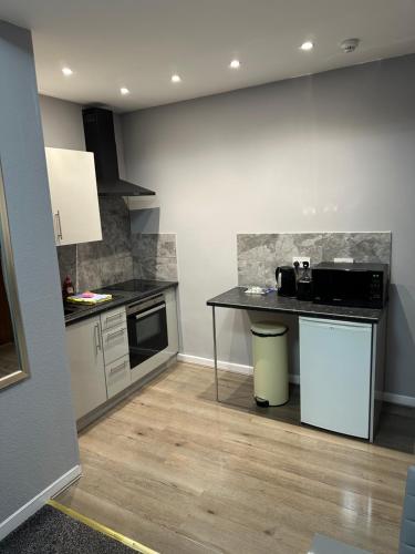 a kitchen with a table and a counter top at Blackpool Beach Holiday Flats in Blackpool