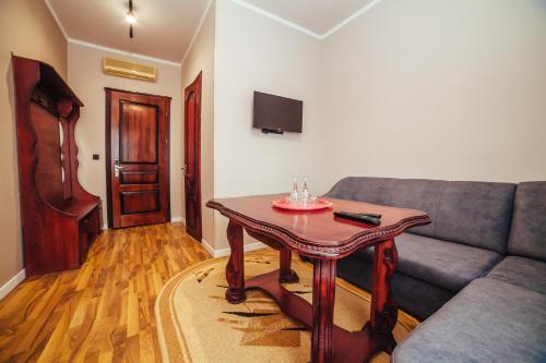 a living room with a couch and a table at Європа готель in Solomonovo
