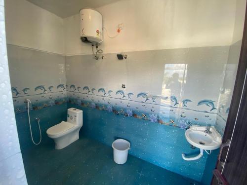 a bathroom with a toilet and a sink at La Antilia Luxury - TIE Hotels in Pondicherry