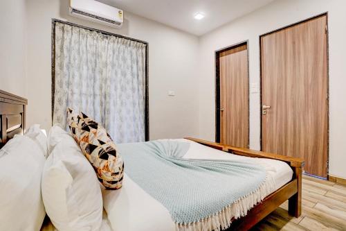 a bedroom with a bed and a window at ELIVAAS 3 BHK Aamy Villa with Pvt Pool & Garden in Lonavala
