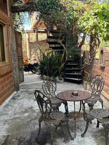 a patio with a table and chairs and a staircase at Villa Wolfsbau in Pai