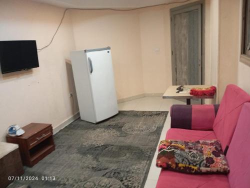 - un salon avec un canapé et un réfrigérateur dans l'établissement شقة في موا بلازا كورنيش النيل اسوان Apartment in Mowa Plaza Aswan Nile Corniche, à Aswān