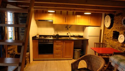 a kitchen with a sink and a stove top oven at Casa Cima in Chãs de Égua