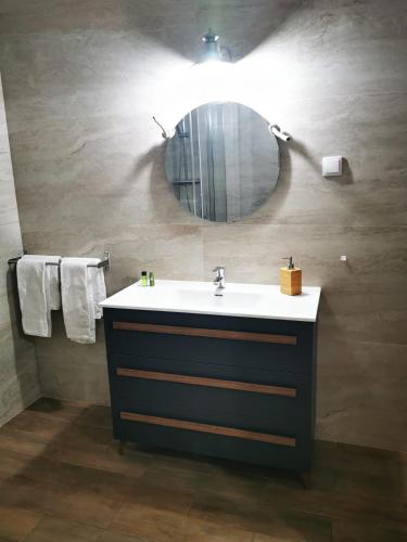 a bathroom with a sink and a mirror at Casa da Nazaré in Portinho da Arrábida