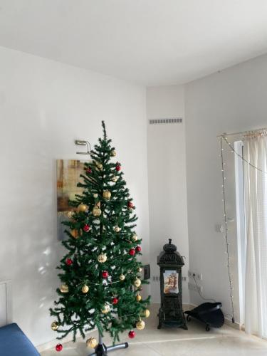 a green christmas tree in a living room at Akdeniz Villa in Kas