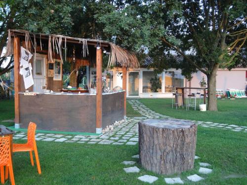 a building with a table and a tree stump at B&B Ai Prati in Monestirolo