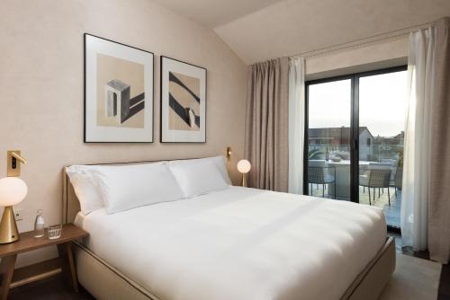 a hotel room with a bed and a large window at master Trevi in Rome