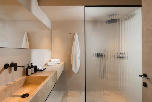 a bathroom with a glass shower and a sink at master Trevi in Rome
