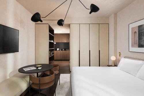 a bedroom with a white bed and a table at master Trevi in Rome