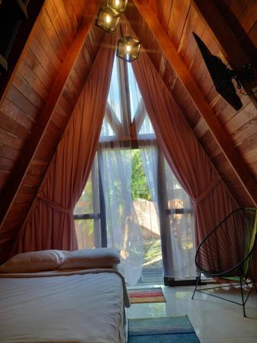 a bedroom with a bed and a large window at Rancho lodge in San Gabriel