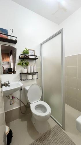 a bathroom with a toilet and a sink and a shower at Home in Butuan City in Butuan