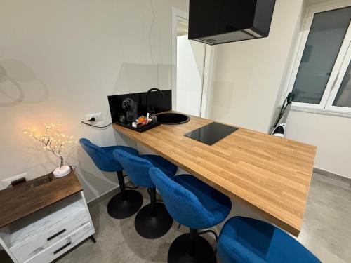 a wooden desk with blue chairs in a room at Stay In Naples - Arenaccia 211 Rooms and Suite in Naples