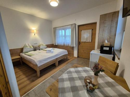 a hotel room with a bed and a television at Riedhof-Zuahaus in Breitenbach am Inn