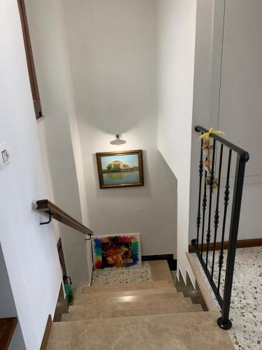 a stairway with a painting on the wall at B&B Casa di Carla in Ripatransone