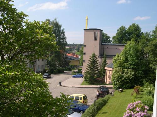 a parking lot with cars parked in front of a building at Haus am Kurpark in Schömberg