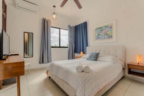 a bedroom with a bed with two towels on it at CHIC Lagoon front Villa by Casa Paraíso in Cancún
