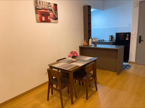 a dining room table and chairs in a kitchen at Maya Bay Gamuda Cove in Banting