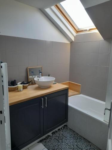 a bathroom with a sink and a bath tub at Country house near Nevers in Cours-les-Barres