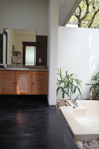 a bathroom with a sink and a mirror at Villa Gita Segara Candidasa in Candidasa