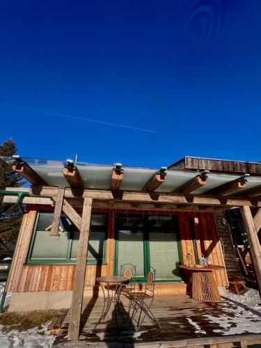 a deck with a table and chairs on a house at Ferienhaus Messner in Hohentauern