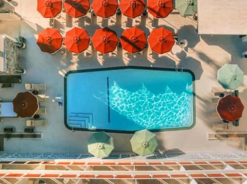 a wall with umbrellas and a swimming pool at Royal Sun Palm Springs in Palm Springs