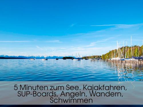a large body of water with boats in it at Grand Villa Berg-Starnberg For Your Vacation, Retreat, Workshop, Corporate and Familys event in Berg am Starnberger See