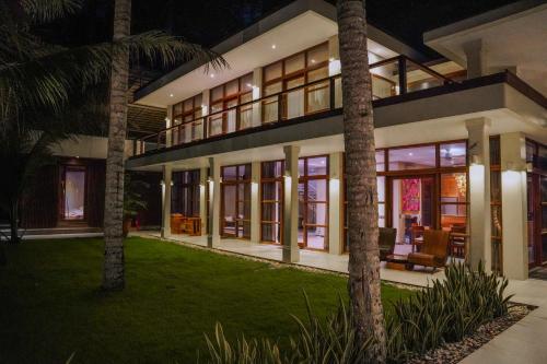 an exterior view of a house at night at Villa Gita Segara Candidasa in Candidasa