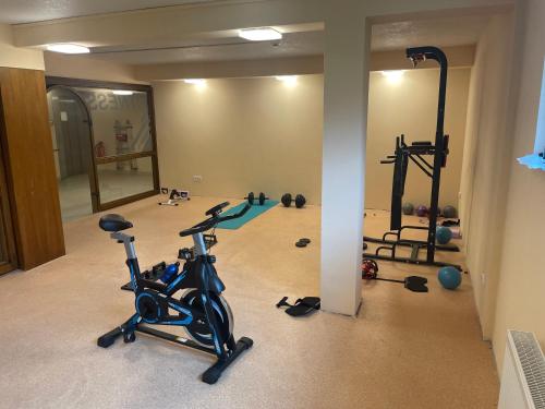a gym with several exercise bikes and treadmills at Hotel Sonnenhof in Bad Waldsee