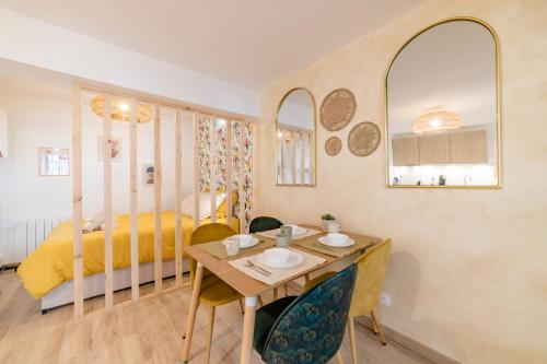Un dormitorio con una cama y una mesa y sillas. en Sollys (Hyper centre - Parking - Cosy), en Auxerre