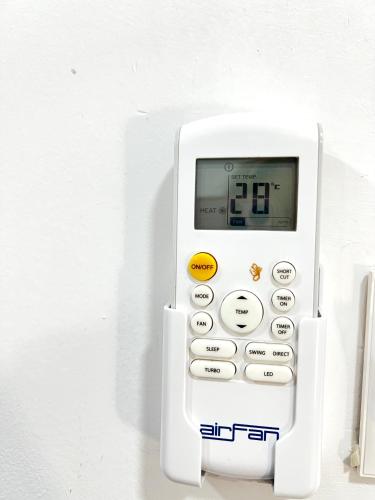 a white calculator is attached to a wall at Tirana Square Hotel in Tirana