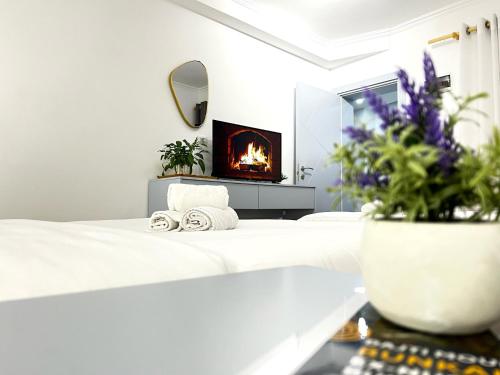 a bedroom with a bed with a fireplace at Tirana Square Hotel in Tirana