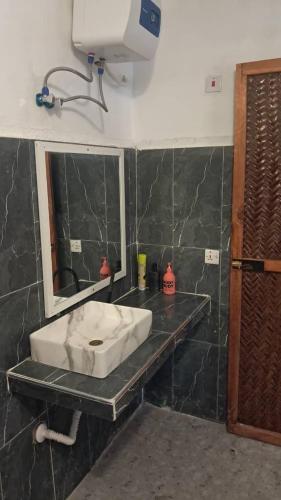 a bathroom with a sink and a mirror at Lala House by Masala Living in Jambiani