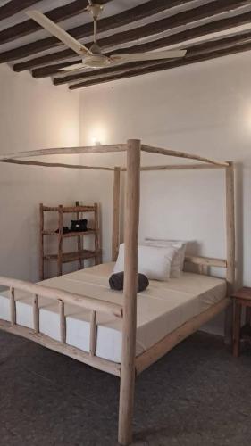 a bedroom with a wooden bunk bed in a room at Lala House by Masala Living in Jambiani