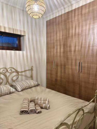 a bedroom with a bed with two pillows on it at the mountain house in parnassus in Eptalofos