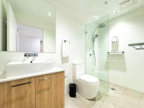 a bathroom with a sink and a toilet and a shower at Urban Sanctuary in West Franklin with Pool & Gym in Adelaide