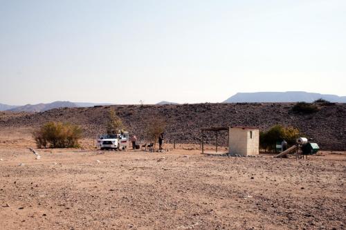 a truck parked in a desert with a dirt field at Neuhof Portion 2 Campsite in Sesriem