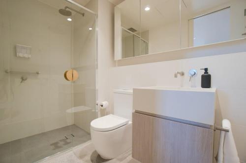 a bathroom with a toilet and a sink and a shower at City Escape at Rundle Mall - Gym & BBQ in Adelaide