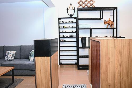 a living room with a couch and a shelf at The Hause in Nakuru