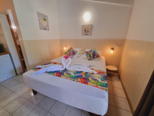 a bed with towels on it in a room at Gites Kaladja in Port-Louis