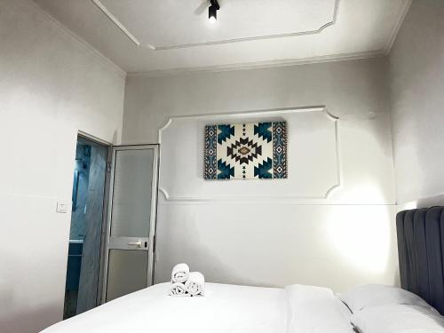 a bedroom with a bed and a picture on the wall at Tirana Square Hotel in Tirana