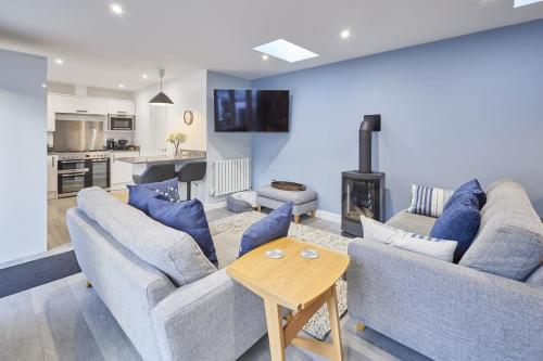 a living room with two couches and a fireplace at Host & Stay - Harrow Bothy in Berwick-Upon-Tweed