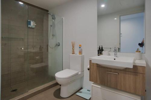 a bathroom with a toilet and a sink and a shower at Modern 2 Bedroom Apartment - Adelaide CBD in Adelaide