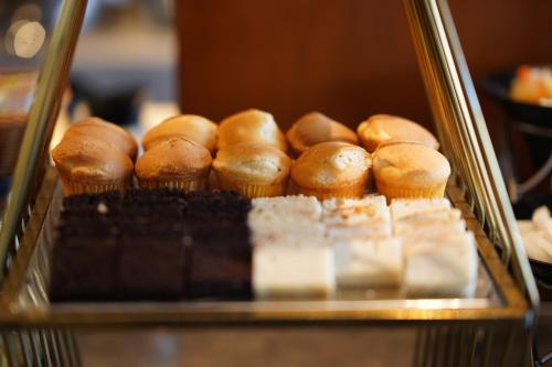 a bunch of donuts on display in a bakery at Best Western Swaran Amritsar in Amritsar