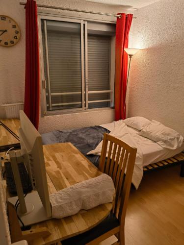Cette chambre comprend un lit et une table avec un bureau. dans l'établissement Apartment - nice view and quiet, à Montpellier
