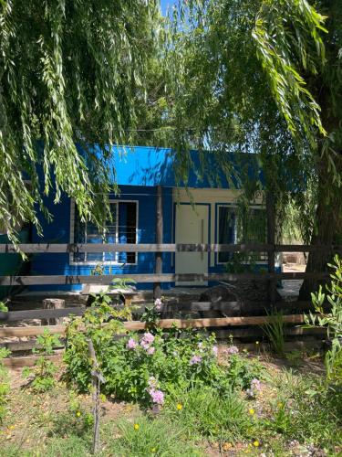 a blue and white house with flowers in front of it at Casa de Playa Mar de Ajo Castelli 1257 Beach House in Mar de Ajó