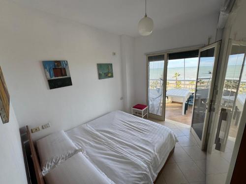 a bedroom with a bed and a view of the ocean at ApartHotel by Comfort Suites in Golem