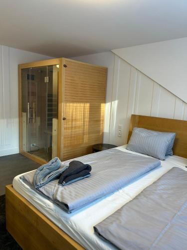 a bedroom with a bed with a towel on it at Luxusní Apartmány Domovjanka - LYSÁ HORA, SMRK, KMÍNEK, SLAVÍČ in Bílá